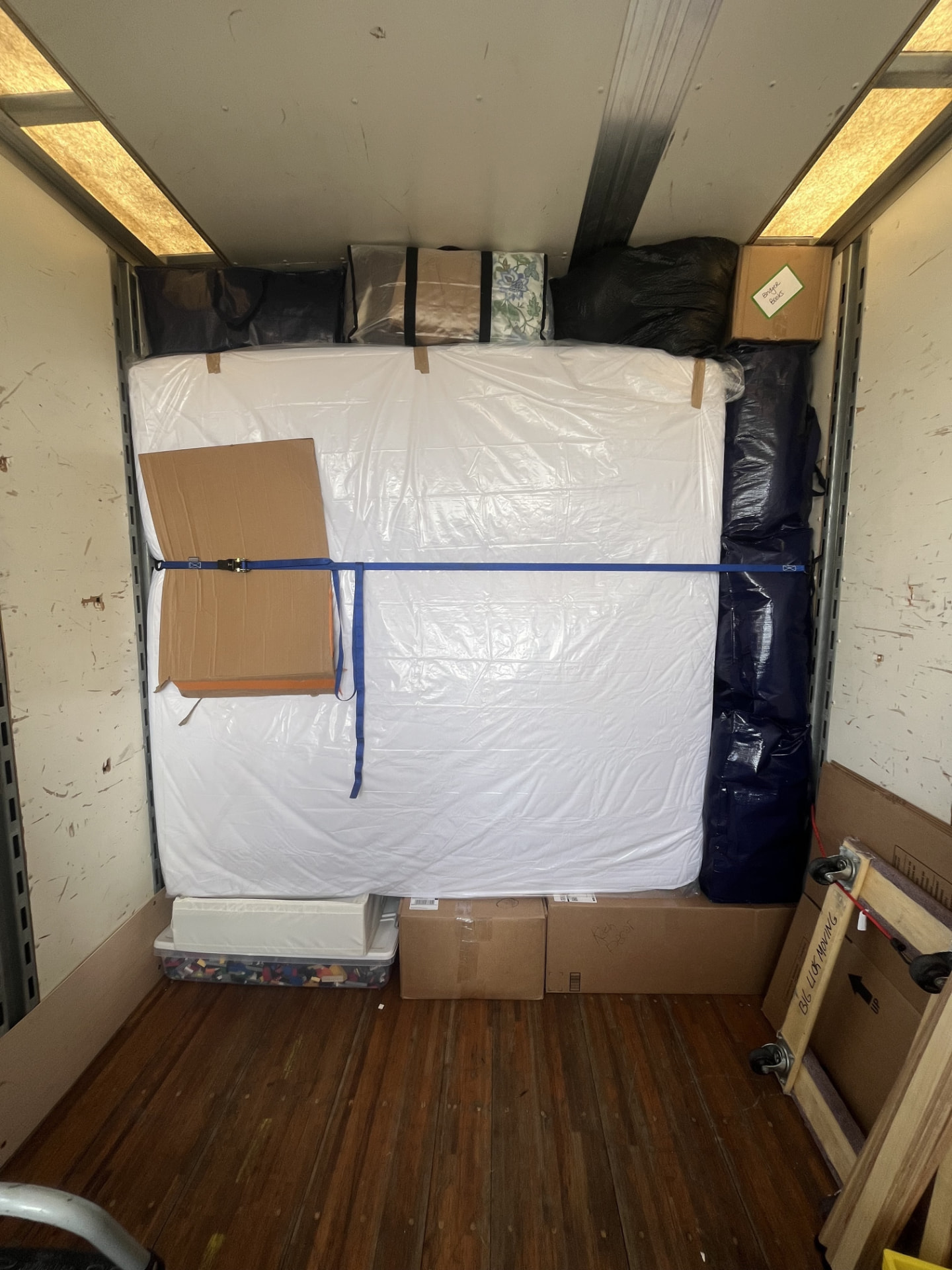 A tightly packed long-distance moving truck load secured with bands
